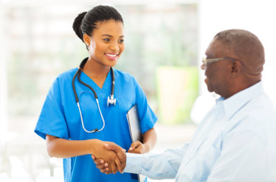 female nurse and senior man shaking hands