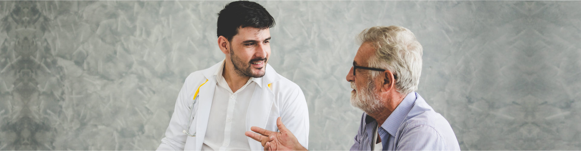 elderly man talking to a doctor