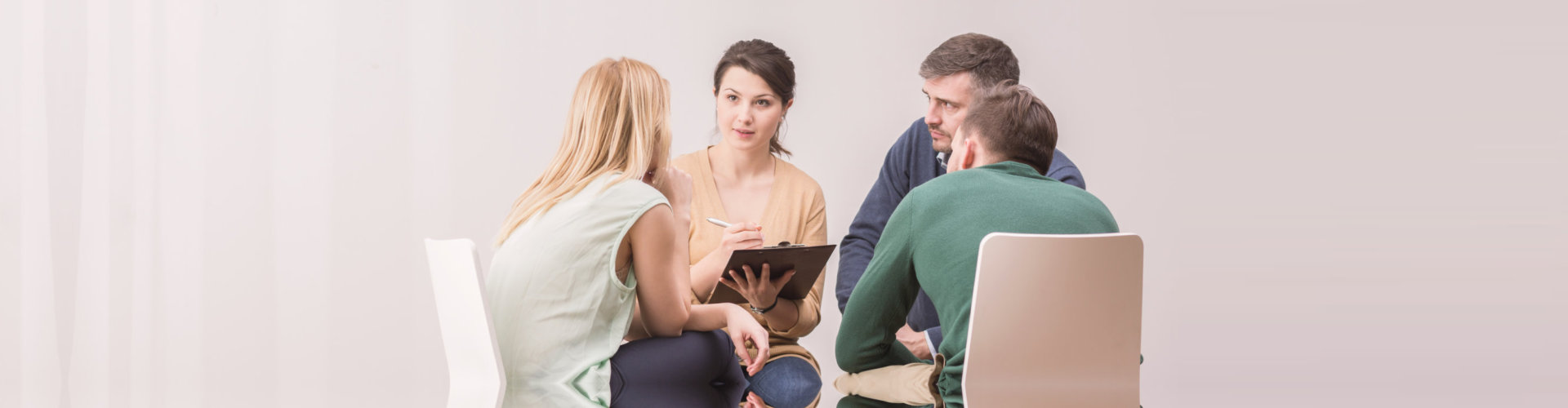 group of people talking to their therapist